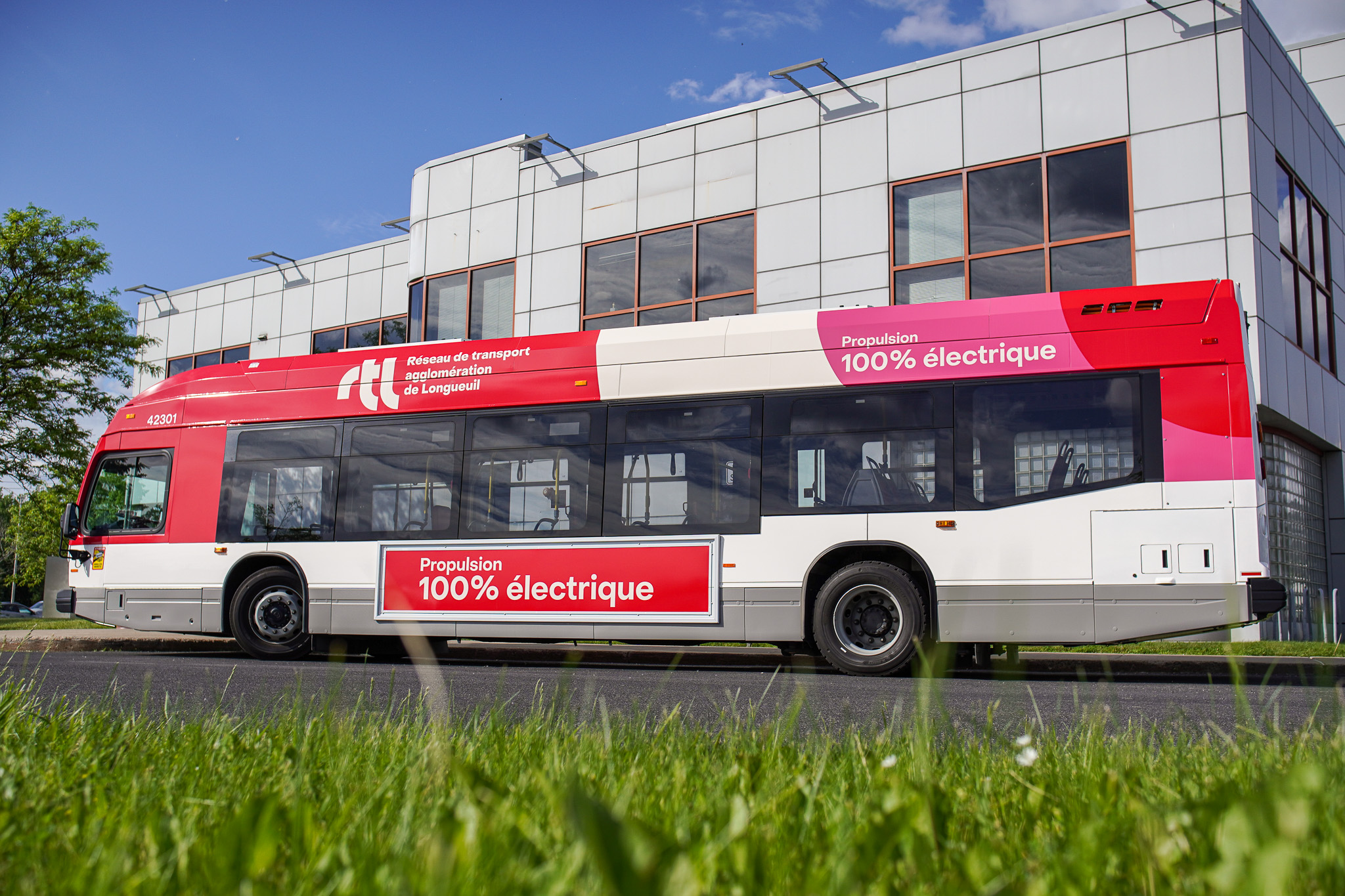 Un autobus circule dans la rue avec des passagers à bord.